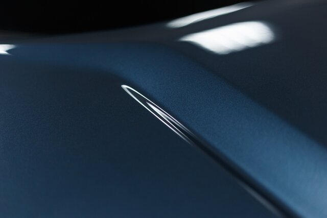 The car's paintwork. Abstract background in classic blue. Trend color. Close up. The texture of the paint